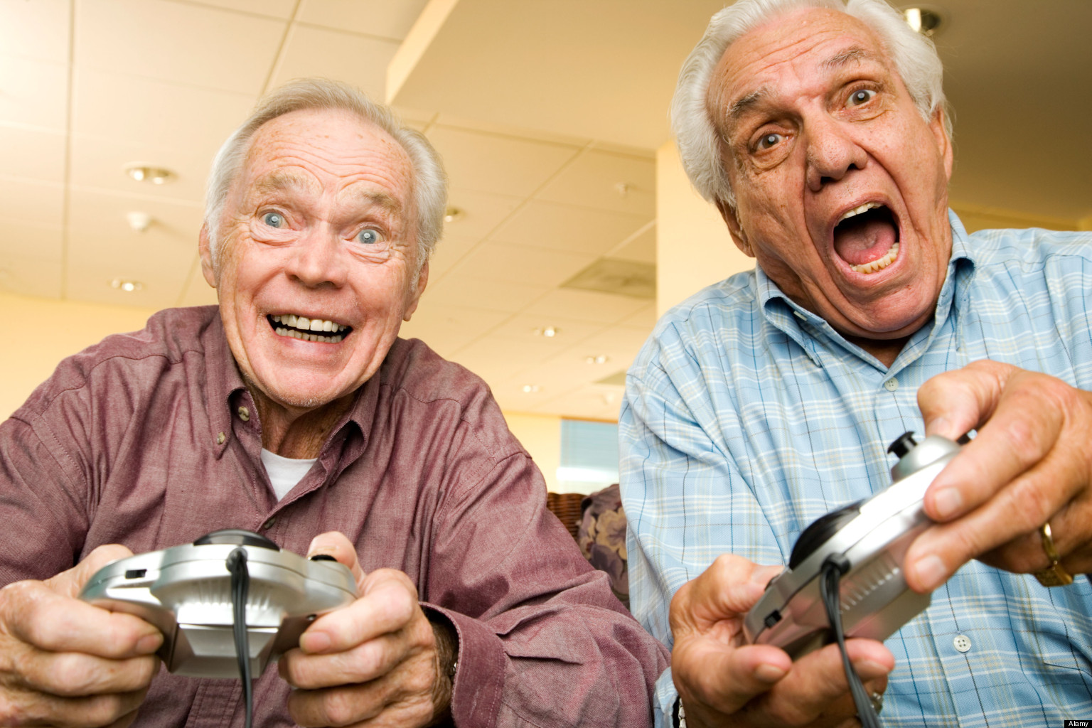 Two elderly men playing a video game